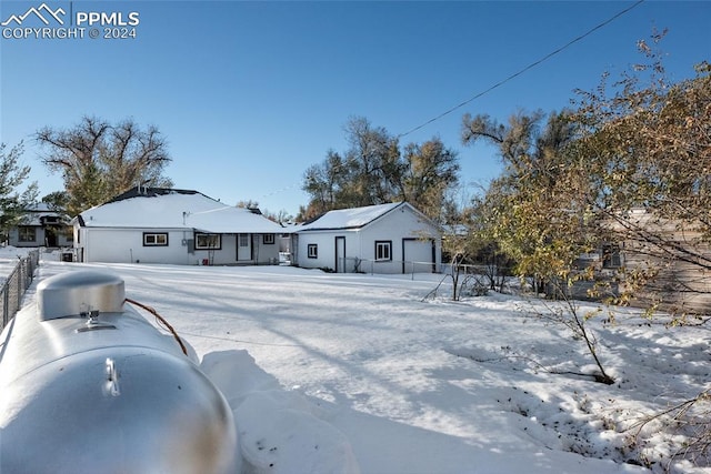 view of snow covered back of property