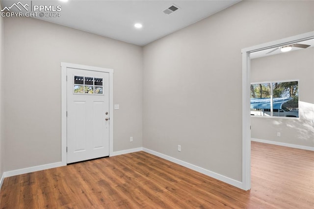 entryway with wood-type flooring and ceiling fan