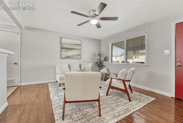 interior space featuring ceiling fan, hardwood / wood-style floors, and a textured ceiling