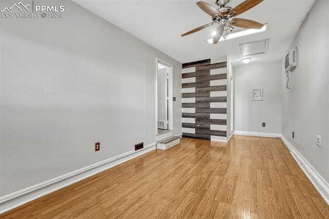 empty room with light hardwood / wood-style floors and a wall mounted AC