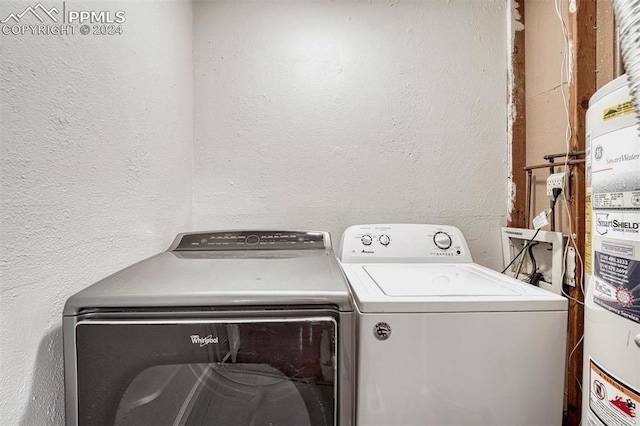 laundry room featuring washing machine and dryer and gas water heater