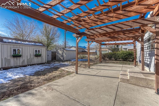 view of patio with a storage unit and a pergola