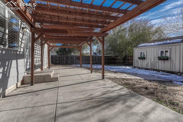 view of patio featuring a storage unit and a pergola