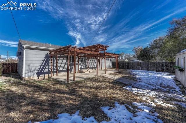 snow covered property featuring a pergola