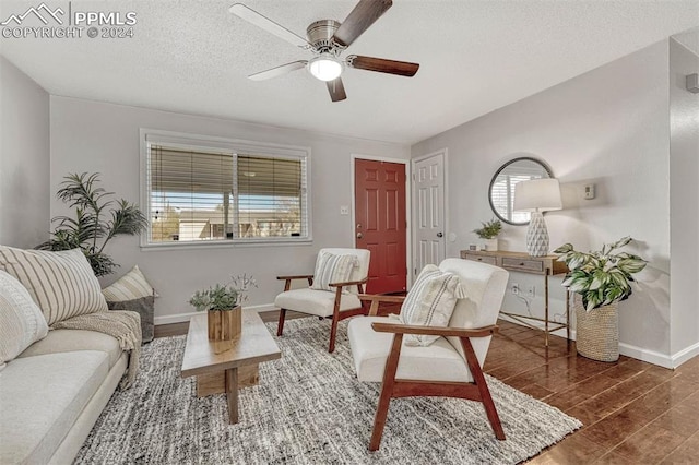 sitting room featuring plenty of natural light, dark hardwood / wood-style floors, a textured ceiling, and ceiling fan