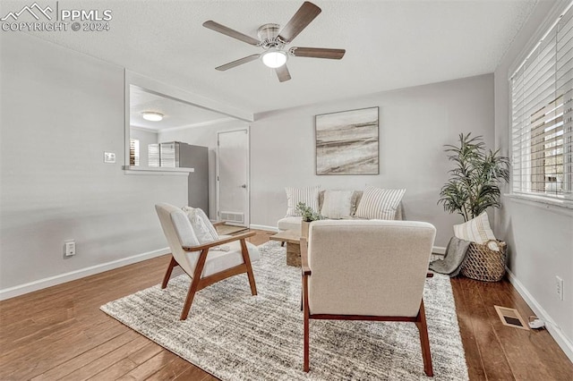 living room featuring dark hardwood / wood-style flooring and ceiling fan