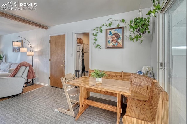 dining area with beam ceiling