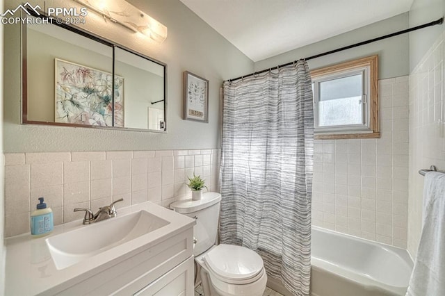 full bathroom with vanity, shower / bath combo, tile walls, and toilet