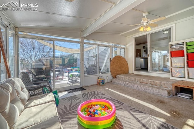 sunroom / solarium with lofted ceiling with beams and ceiling fan