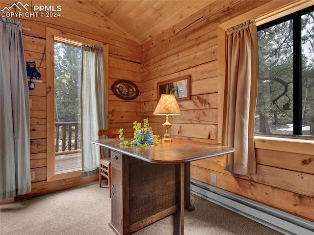 carpeted home office featuring a baseboard heating unit, wooden walls, vaulted ceiling, and wooden ceiling