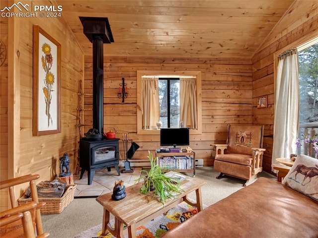 carpeted living room featuring wood walls, wood ceiling, vaulted ceiling, and a wood stove