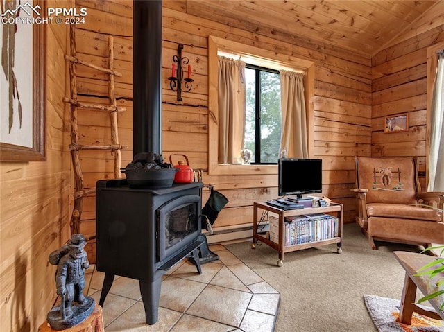 interior space featuring lofted ceiling, a wood stove, wooden walls, light tile patterned floors, and wooden ceiling