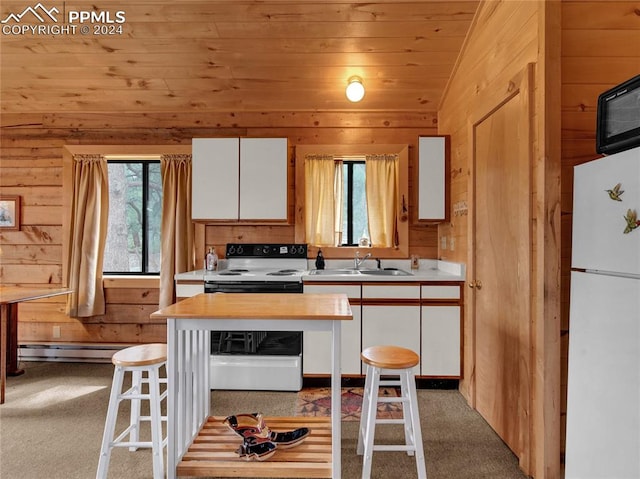 kitchen featuring white appliances, sink, a kitchen breakfast bar, and white cabinets