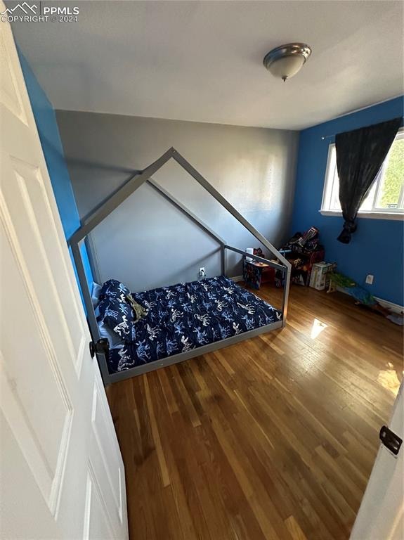 unfurnished bedroom with hardwood / wood-style floors