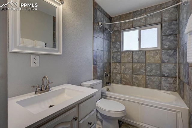 full bathroom with toilet, vanity, and tiled shower / bath