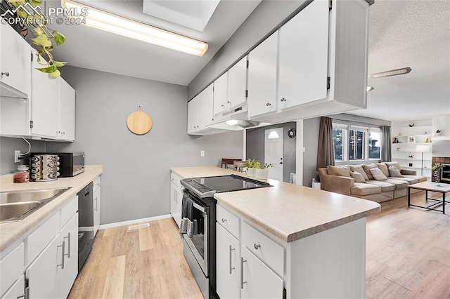 kitchen featuring light wood-type flooring, a textured ceiling, stainless steel appliances, sink, and white cabinetry