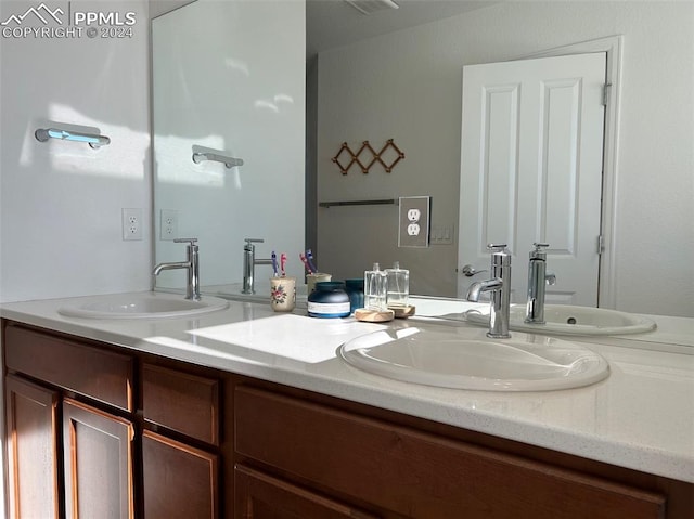 full bathroom with double vanity and a sink