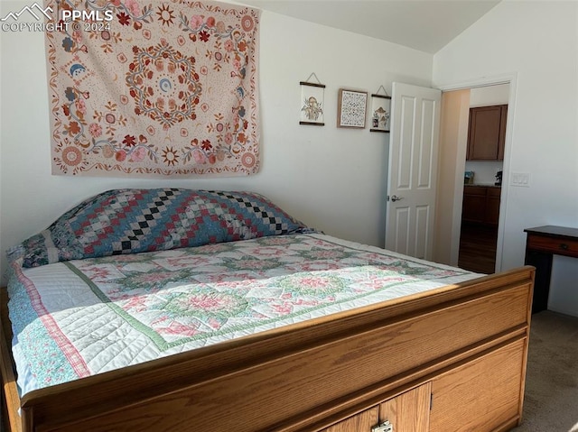 bedroom with carpet floors and vaulted ceiling