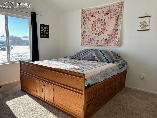 carpeted bedroom with vaulted ceiling