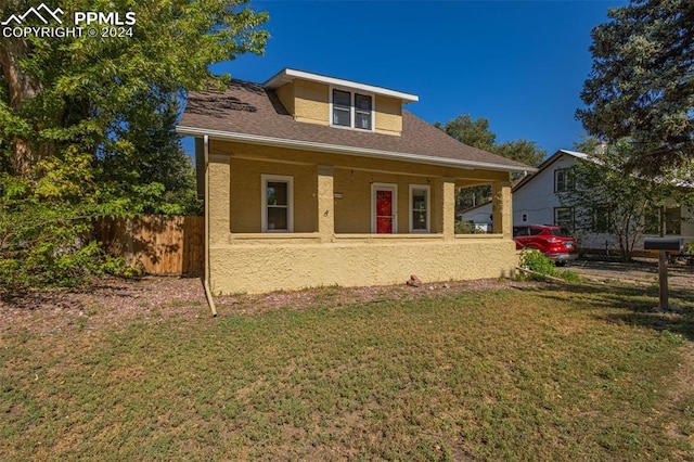 view of front of house featuring a front yard and covered porch