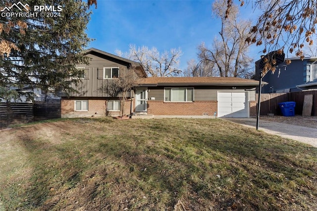 split level home with a garage and a front yard