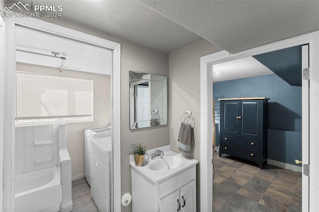 bathroom featuring vanity, shower / bath combination, and a textured ceiling