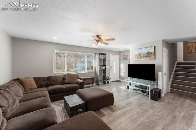 living room with light hardwood / wood-style floors and ceiling fan