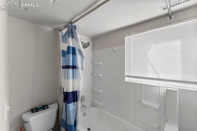 bathroom with toilet and shower / tub combo with curtain