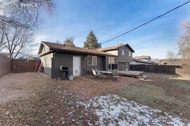 snow covered property with a deck