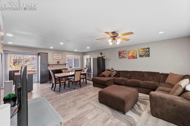 living room featuring light wood-type flooring and ceiling fan