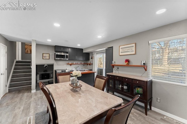 dining room featuring light hardwood / wood-style flooring and sink