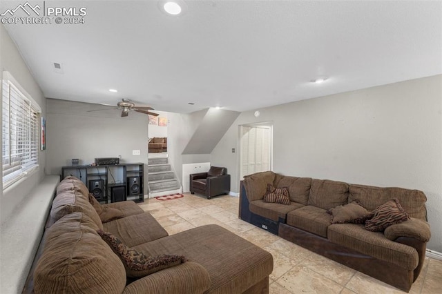 living room with ceiling fan and light tile patterned floors