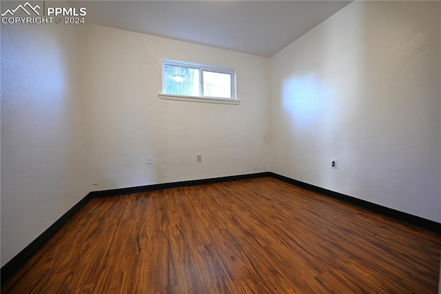 unfurnished room with hardwood / wood-style floors