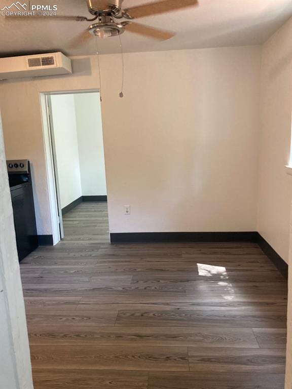 spare room featuring ceiling fan and dark hardwood / wood-style flooring