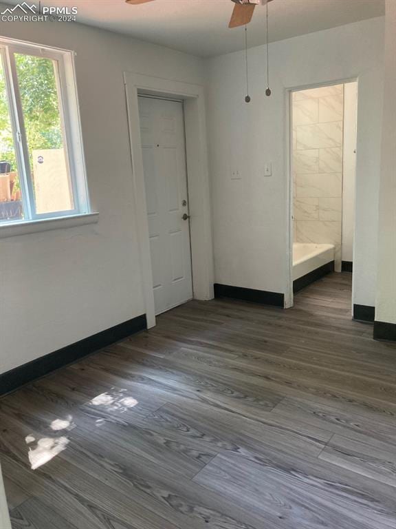 spare room featuring ceiling fan and dark hardwood / wood-style flooring