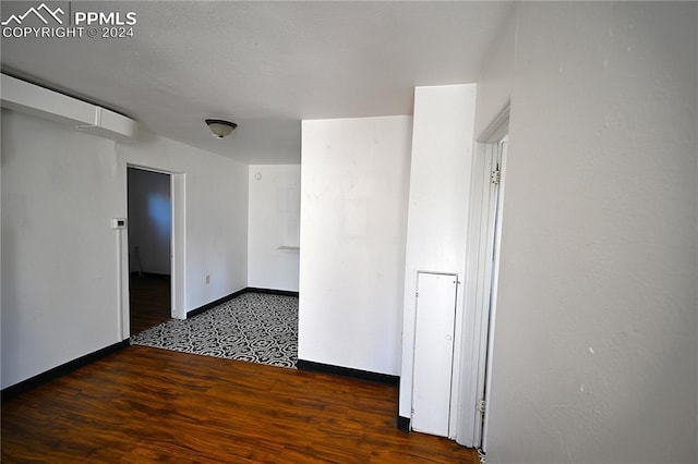 spare room featuring dark wood-type flooring