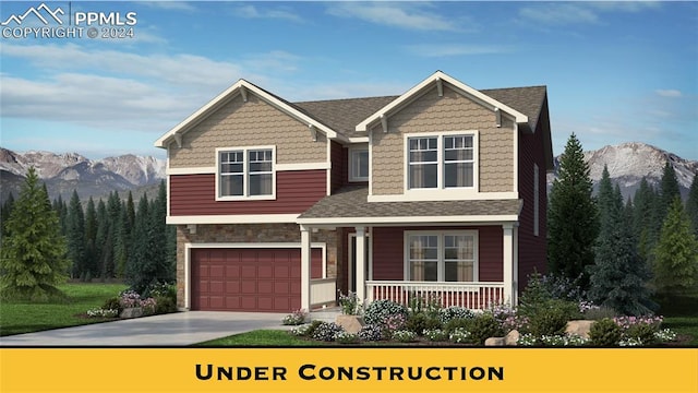 craftsman house with a mountain view, a garage, and covered porch