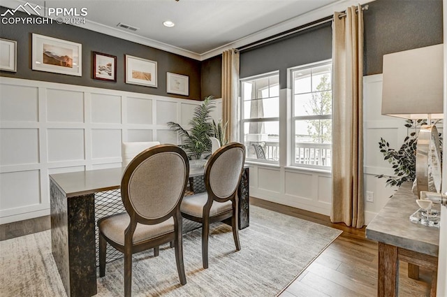 interior space with wood-type flooring and ornamental molding