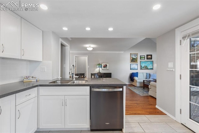 kitchen with backsplash, sink, dishwasher, light hardwood / wood-style floors, and white cabinetry