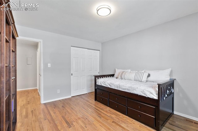 bedroom featuring a closet and light hardwood / wood-style flooring