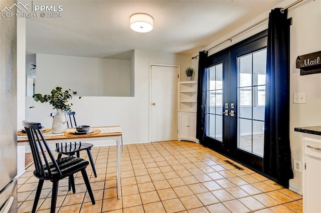 doorway to outside with french doors and light tile patterned floors