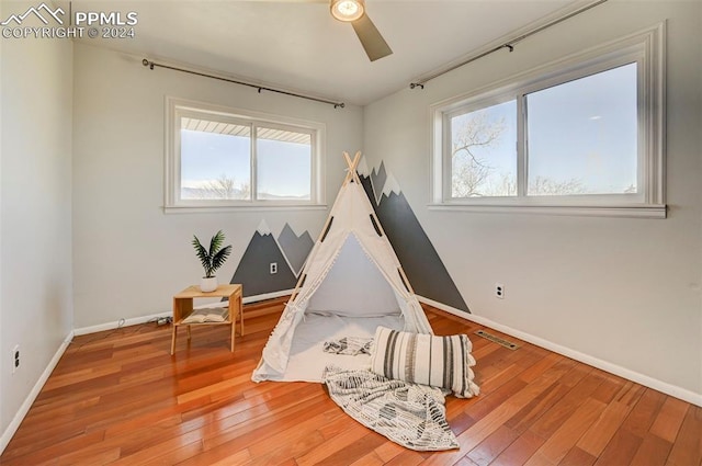 game room featuring hardwood / wood-style floors and ceiling fan