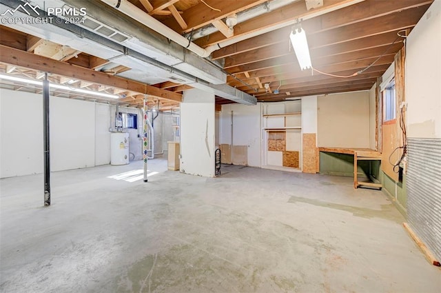 basement featuring heating unit and water heater