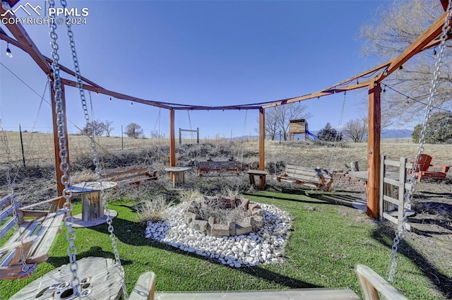 view of yard with a rural view and a fire pit