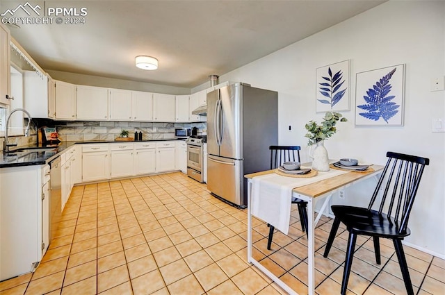 kitchen with white cabinets, appliances with stainless steel finishes, and sink