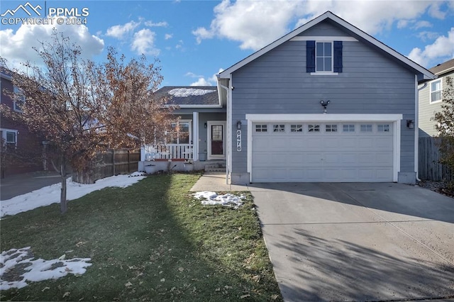 view of front of property with a front lawn and a garage