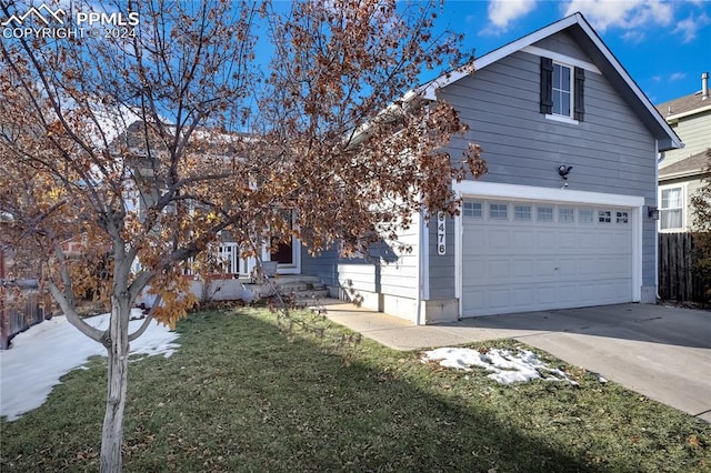 view of front facade featuring a front yard and a garage