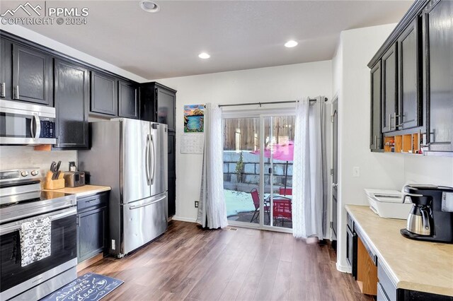 kitchen with dark hardwood / wood-style floors and stainless steel appliances