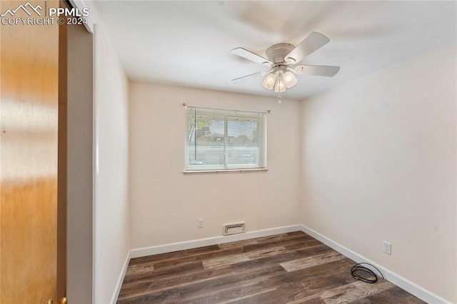 spare room with ceiling fan and dark hardwood / wood-style flooring