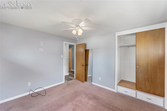 unfurnished bedroom featuring carpet flooring, ceiling fan, and a closet